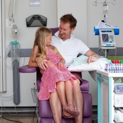 Mark's stepdaughter sits whit him while he receives cancer treatment at The Royal Marsden