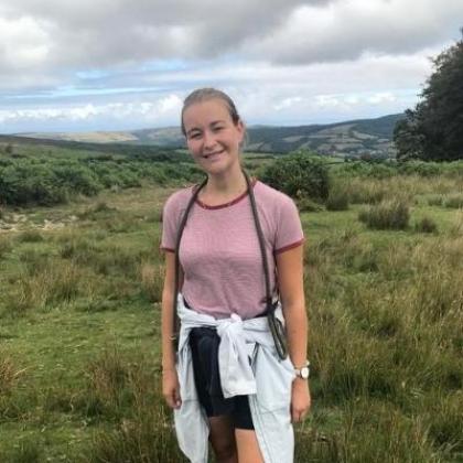 Banham employee, Laura stands in a field smiling for the camera