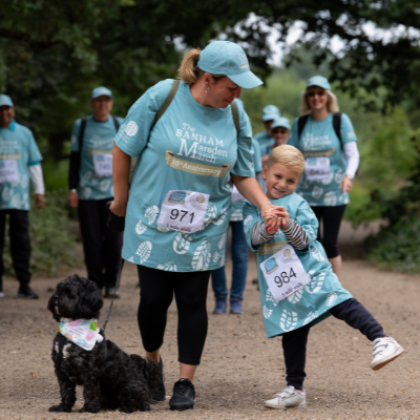 Family wearing Blue Banham Marsden March Shirts with their black dog