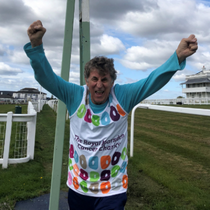 Bob Pain wearing his Royal Marsden Cancer Charity Marathon vest and cheering 