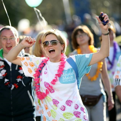 Laura celebrating crossing the finish line of The Banham Marsden March