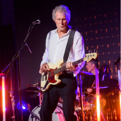 John Illsley of Dire Straits on stage with his electric guitar