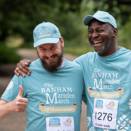 Two men in Banham Marsden March clothing laugh together