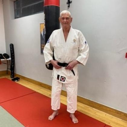 Arthur wearing his martial arts sports wear and blackbelt.