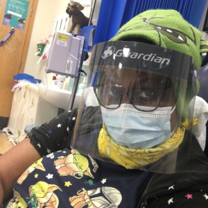 Miranda wearing a face mask and visor while receiving treatment during the Covid-19 pandemic.