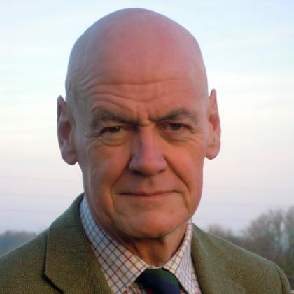 Ian wearing a shirt and tie looking into the camera