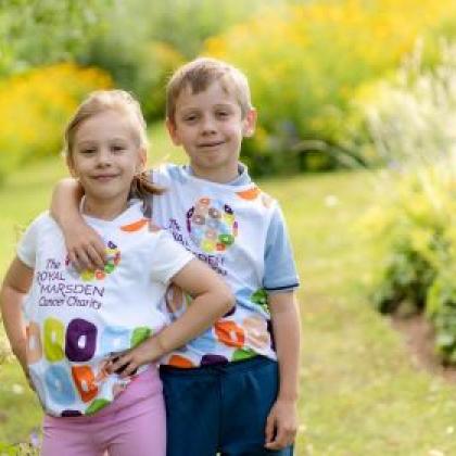 Two children wearing colourful Royal Marsden Cancer Charity running vests
