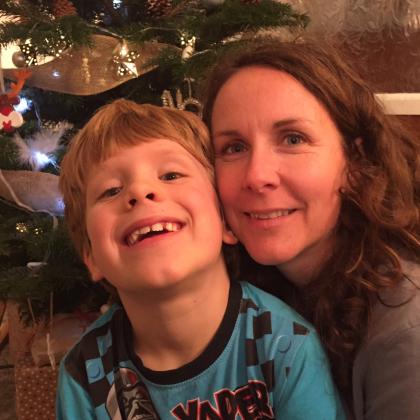 Brock with his mum Bonnie in front of a Christmas tree.