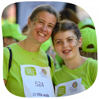Mother and daughter smiling. they have glitter on their faces and are wearing The Banham Marsden March 22 t-shits and numbers.