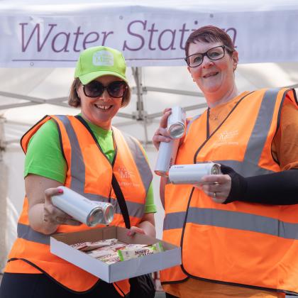 Two volunteers handing out snack and water at one of the checkpoints on The Banham Marsden March