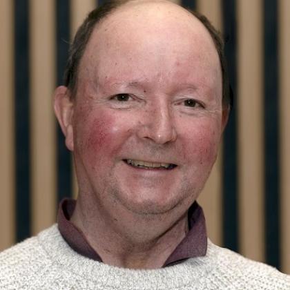 Headshot of a Royal Marsden patient in the Oak Cancer Centre. He is smiling and wearing a shirt with a knitted jumper