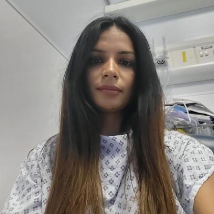 A patient in a robe, sitting in a hospital room at The Royal Marsden