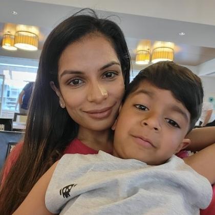 Royal Marsden patient Sara smiling with her young son sitting on her lap