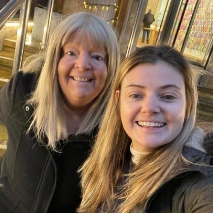 Nicky smiling with one of her daughters 