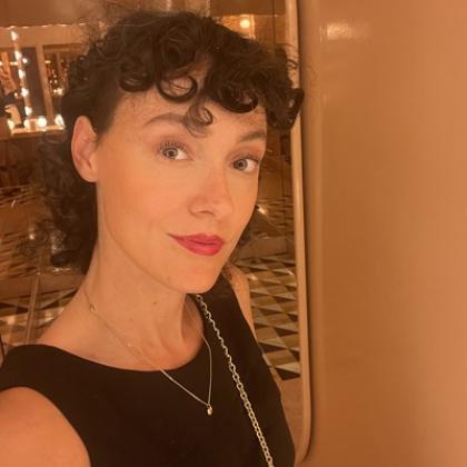Selfie of a woman with black curly hair