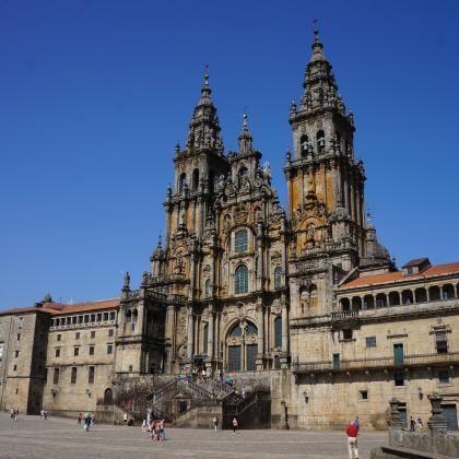 The beautiful gothic exterior of the catedral de santiago de compostela on a sunny day with a bright blue sky