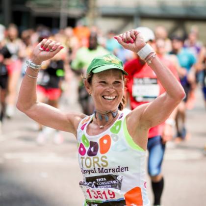 Team Marsden runner, Victoria, raises her hands in the air and smiles during London Marathon 2025