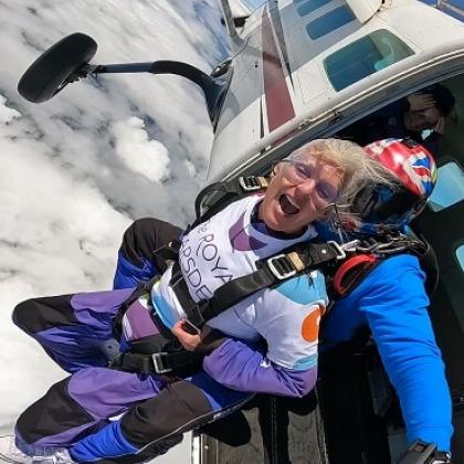 Royal Marsden skydiver with a big smile on as she is jumping out of the plane!