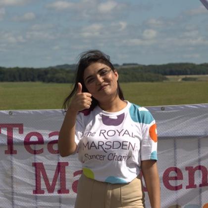 Person in Royal Marsden Cancer Charity t-shirt giving a thumbs up and smiling