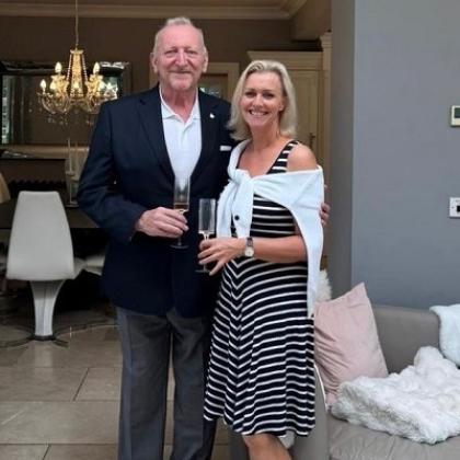 Alastair standing in a restaurant with his partner Jayne