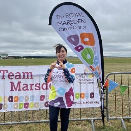 Team Marsden skydiver in charity t-shirt, smiling and making heart with hands