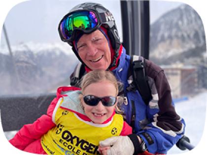 Stuart with his granddaughter, on holiday wearing ski wear