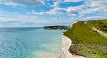South downs coastal walk. View of blue sea and sky and the edge of the seven sisters cliffs.