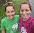 Two smiling women take a selfie in their Royal Marsden Running shirts. 