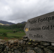 A public footpath sign pointing towards Coniston Old Man