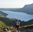 Two Trekkers on Old Man Coniston, Lake District - a stunning view of mountains surrounding a lake