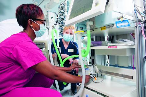 Two CCU team members using equipment