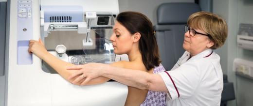 Nurse helping woman with mammogram