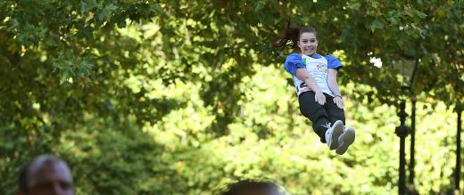 A volunteer thrown in the air as part of cheerleader display at The Royal Parks Half Marathon