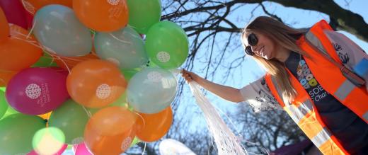 Volunteer with balloons