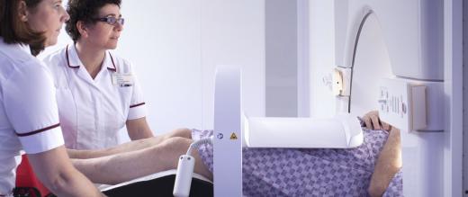 A patient enters the MR Linac helped by two nurses