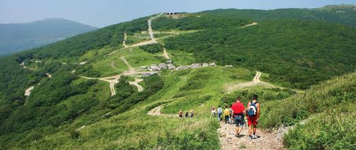 Ramblers on a path on a beautiful hilly landscape