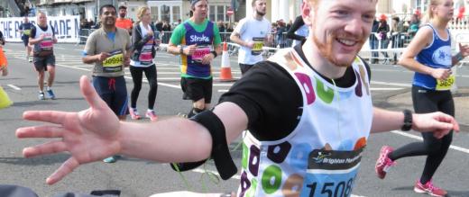 Brighton Marathon supporter high fives a smiling runner. 