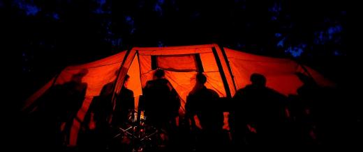 People in tent at night