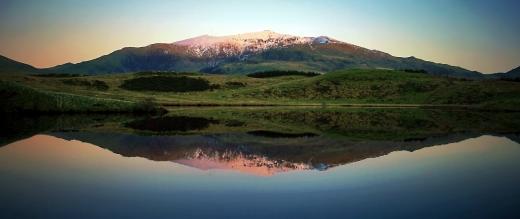 Dawn at Mount Snowdon shown reflected in a lake