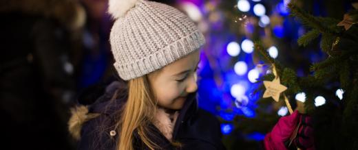 Girl looking at the stars on the Christmas tree