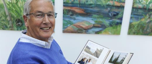 Peter Crisford with photo album