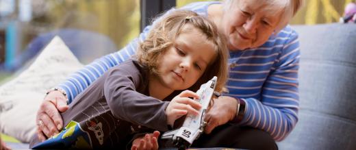 Lottie and her grandma playing with a toy rocket