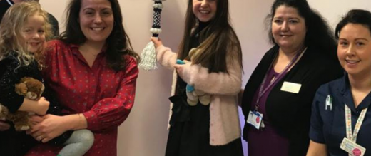 Lila ringing the end of treatment bell