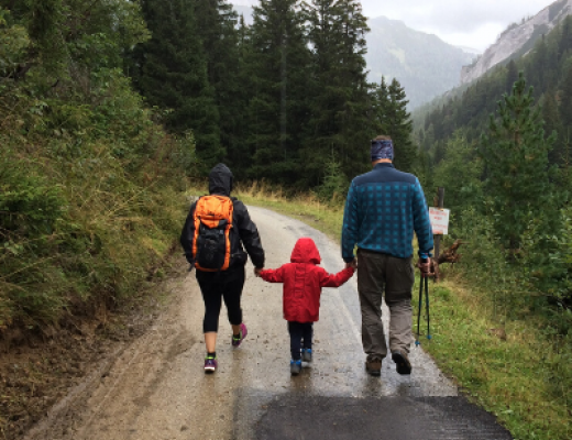 family walking in the woods
