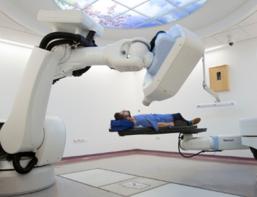Image of the cyberknife machine with a patient lying down under it