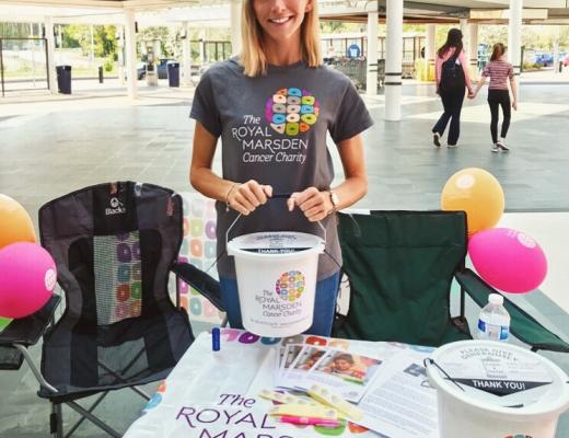 Image of a woman with a money collection bucket raising funds for the charity