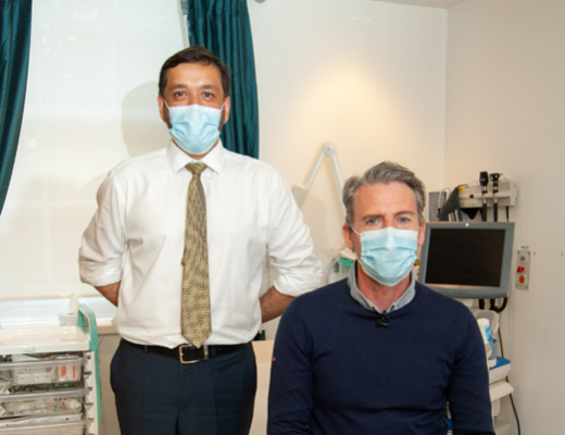 Patient wearing a mask with his doctor