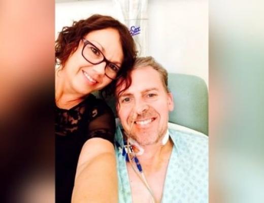 Patient, Mark, smiling in hospital with his wife