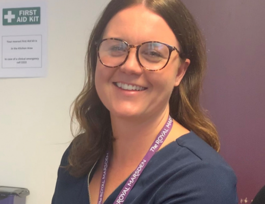 Sinead Golledge, sitting at her desk and smiling