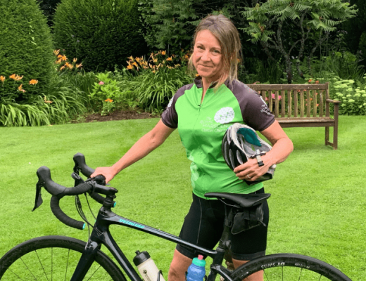 Janet Hanwell in a garden with her bicycle